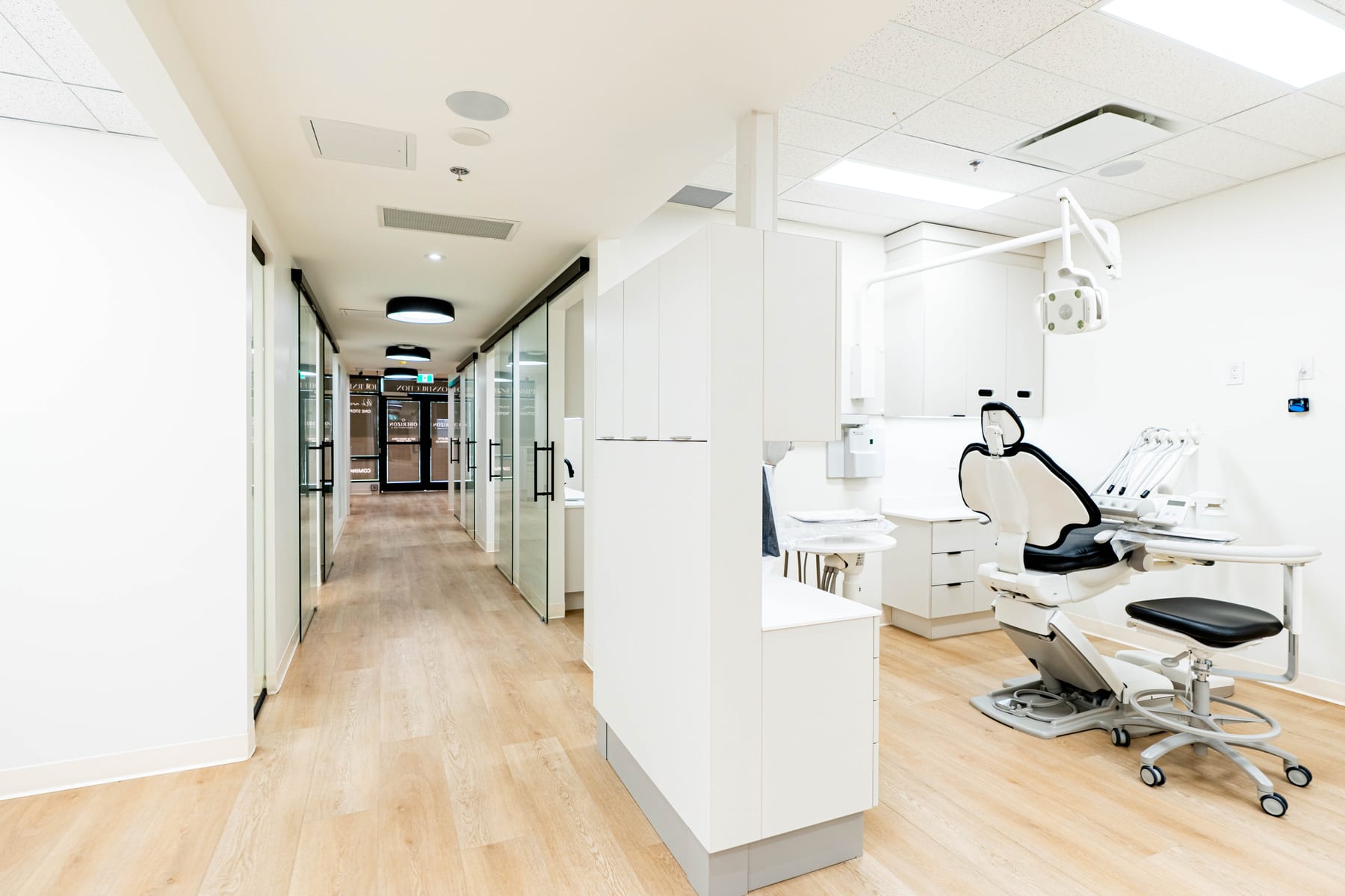 Clinic corridor looking through to a completed dental operatory