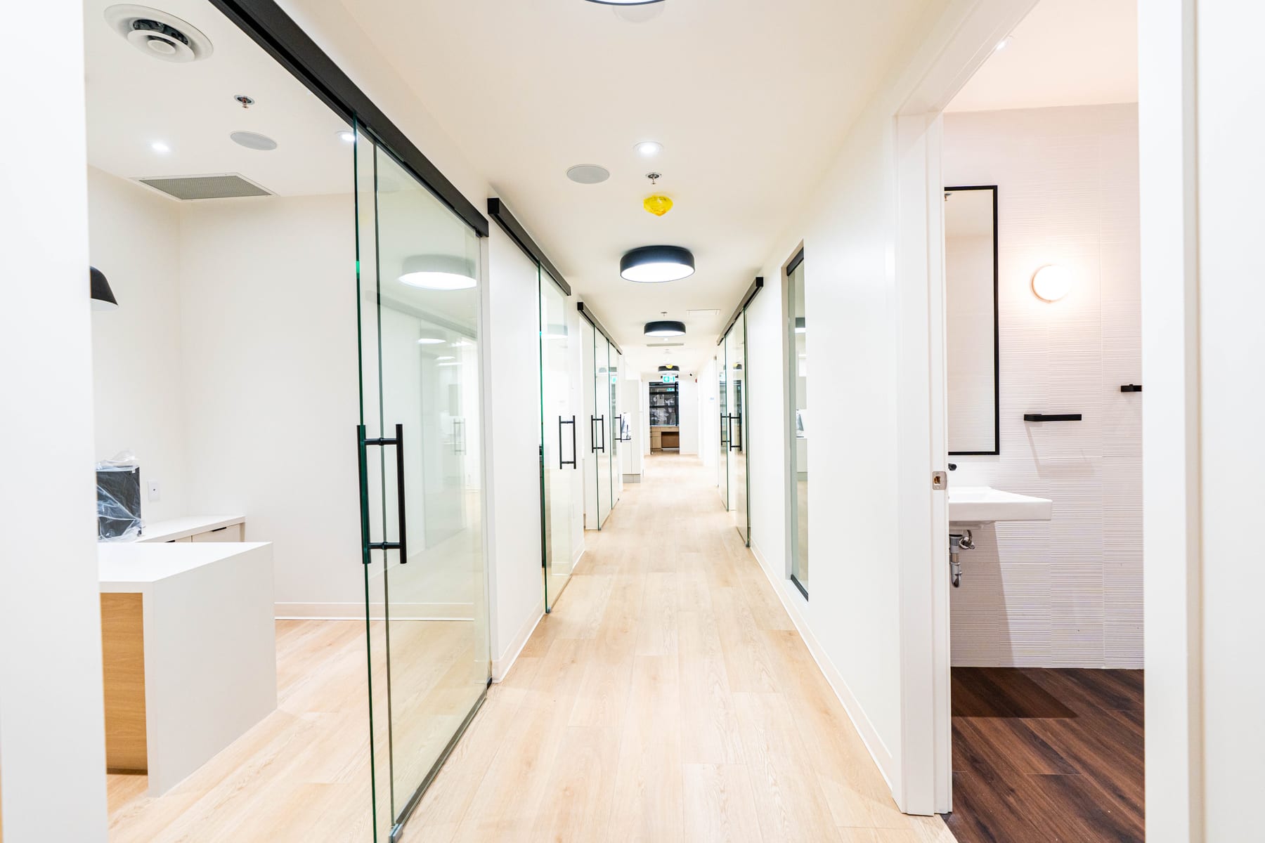 Glass-walled operatory corridor in a completed dental clinic