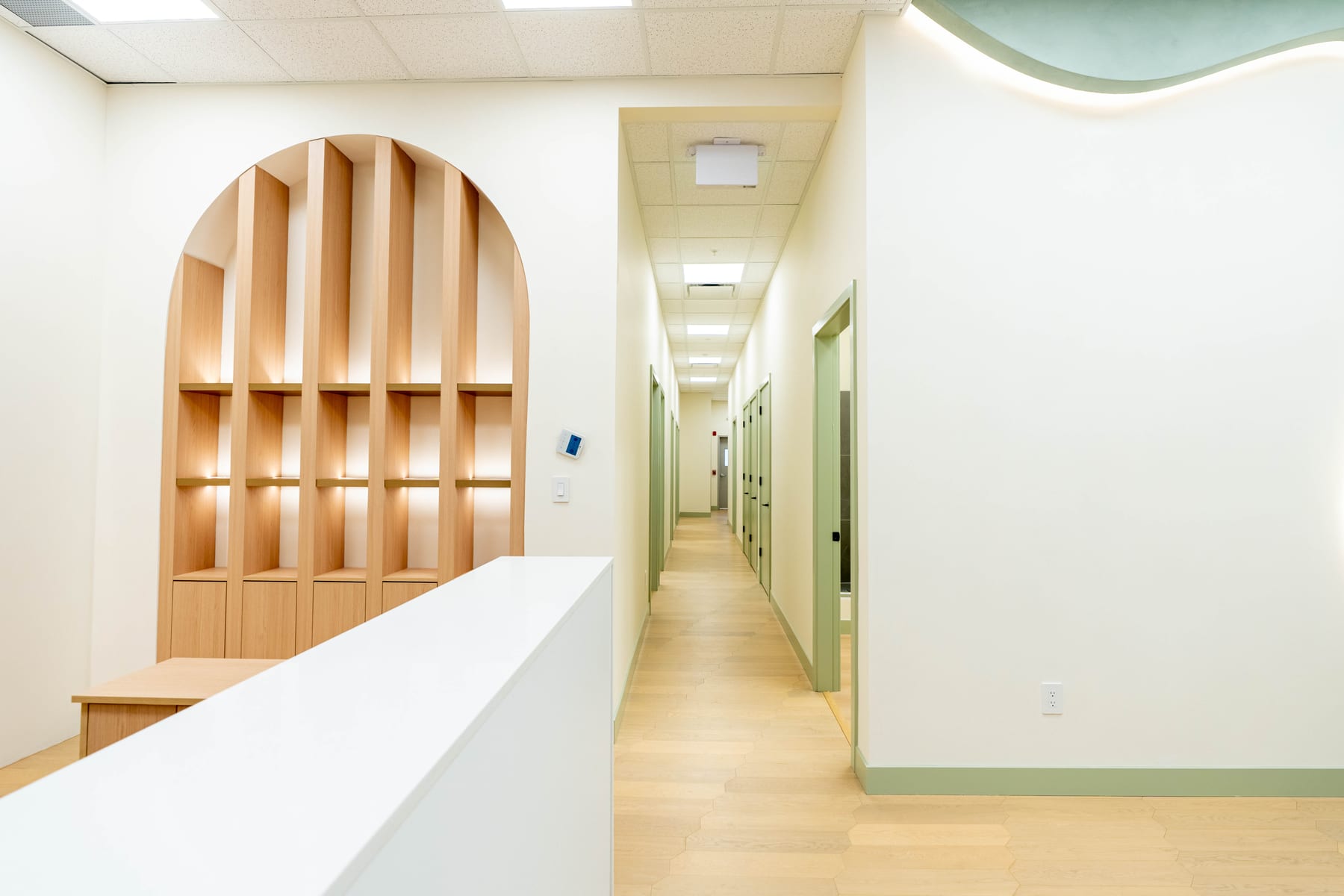 Reception desk and arched display millwork in a completed medical clinic