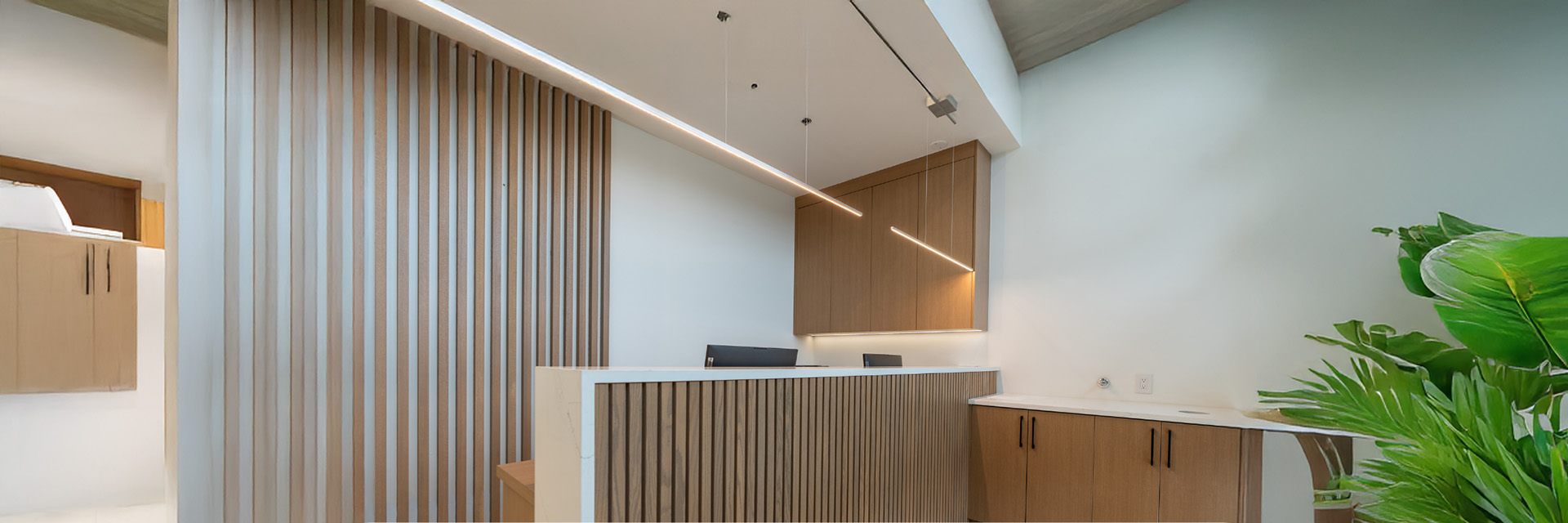 Timber-slat reception desk in a completed clinic interior